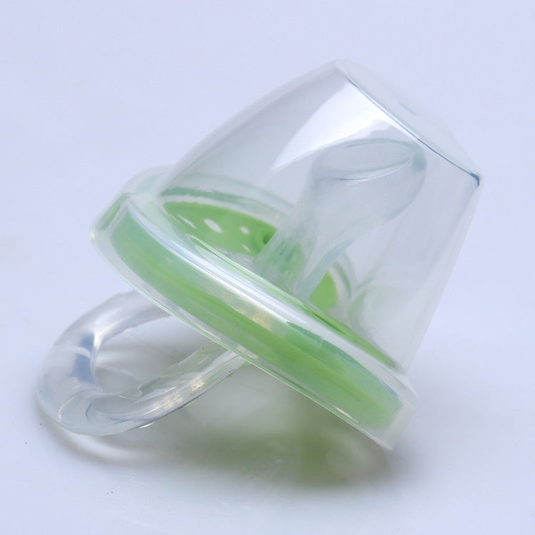 Clear pacifier with green rim on a light gray background