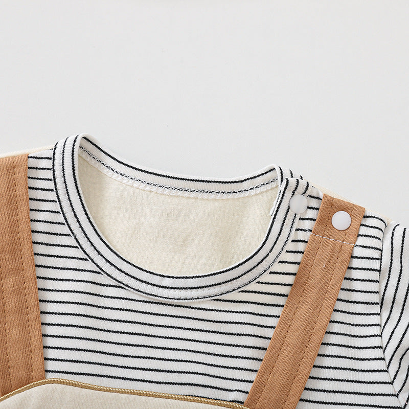 Close-up of a child's outfit with a striped shirt and brown overalls on a light gray background