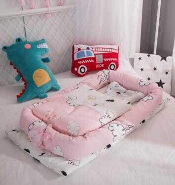 Children's room with a pink and white crib, plush toys, and decorative pillows.
