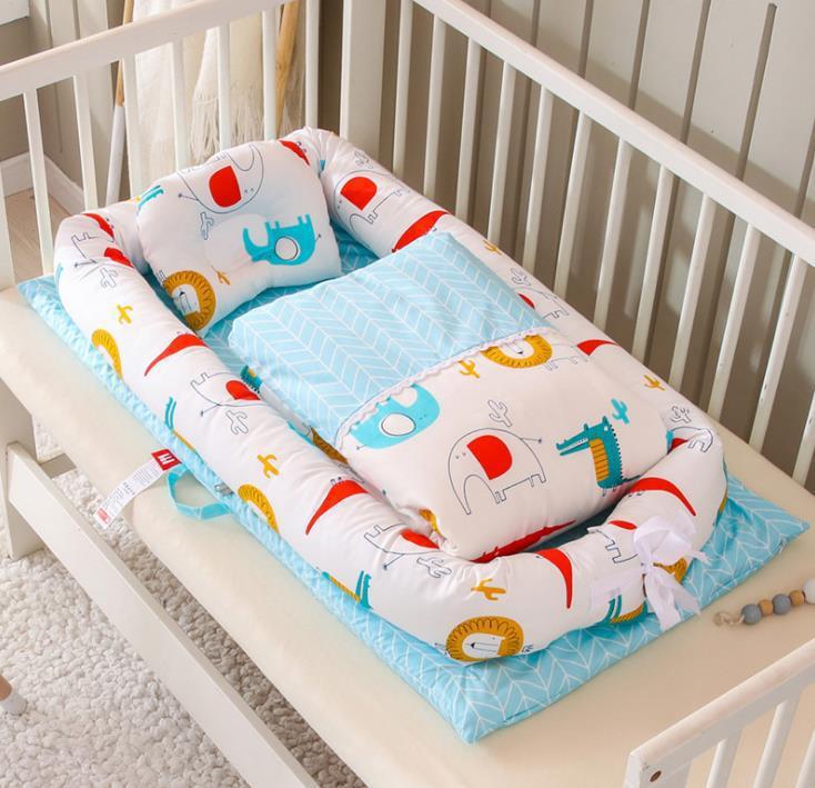 Baby crib bumper with colorful animal patterns on a white crib
