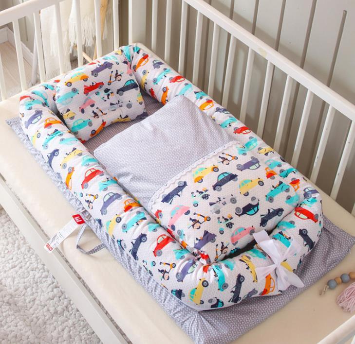 Baby crib bumper with colorful car pattern on a crib