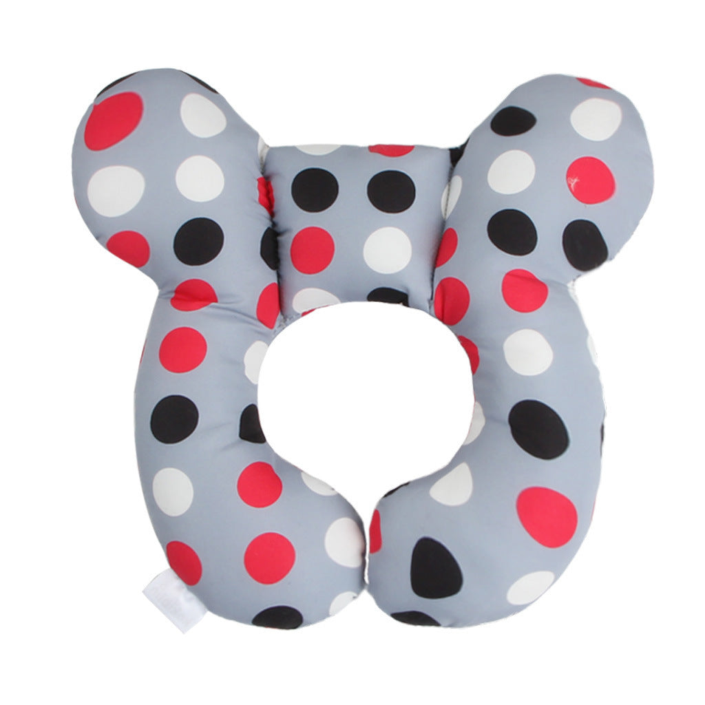 U-shaped pillow with polka dot pattern on a white background