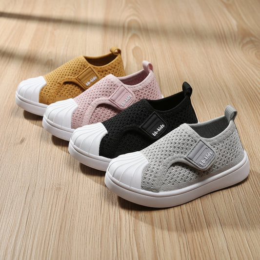 Four children's slip-on shoes in different colors on a white background