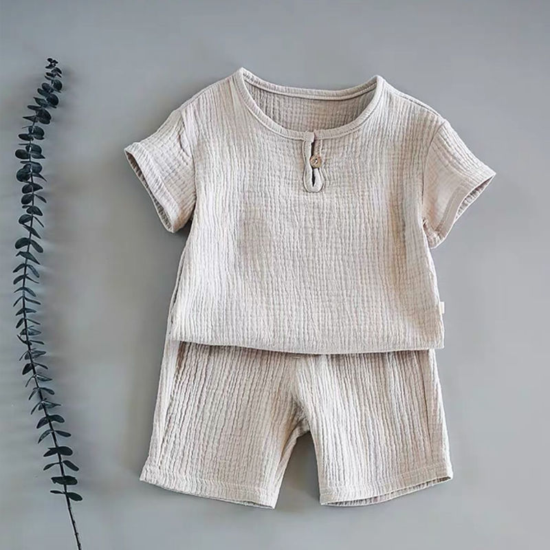 Close-up of baby summer outfit showing soft cotton blend and fold details
