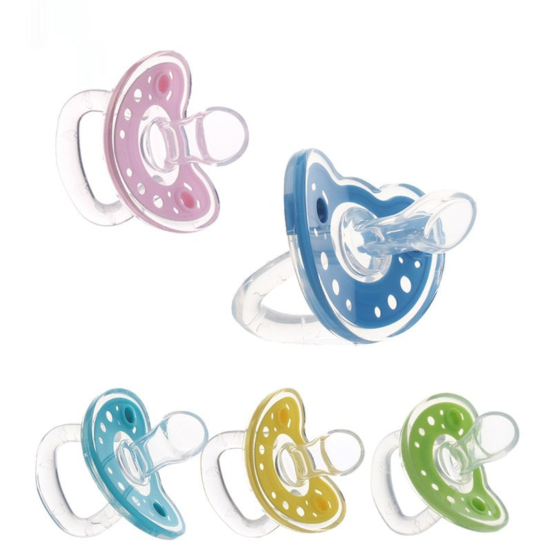 Set of five colorful baby pacifiers on a white background