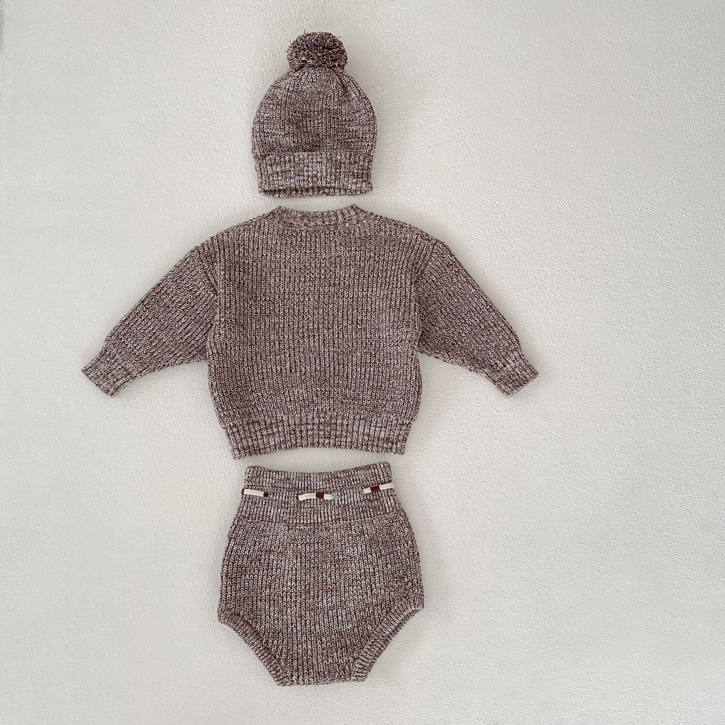 Close-up of baby girl knit set with elegant European-American design details