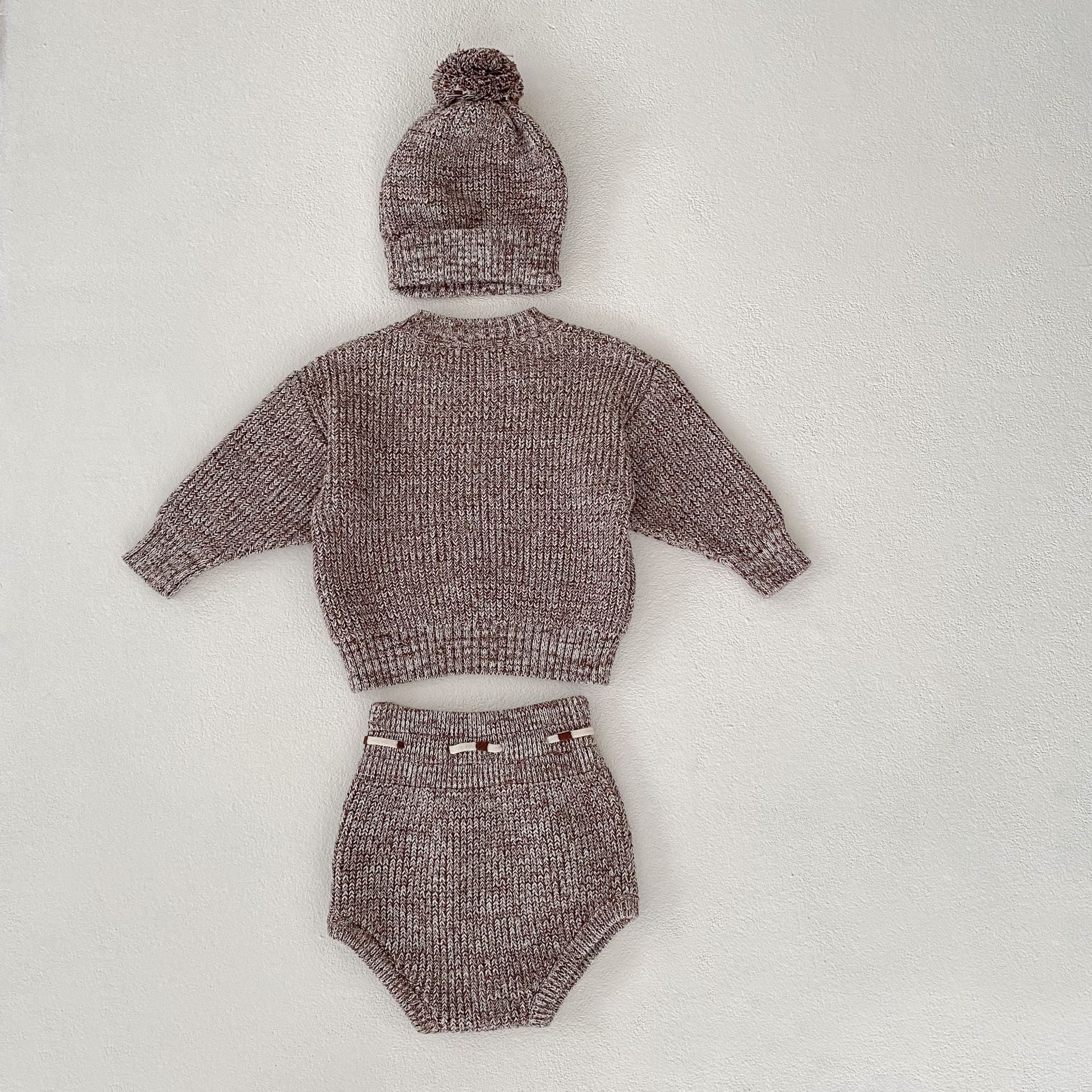 Close-up of baby girl knit set with elegant European-American design details