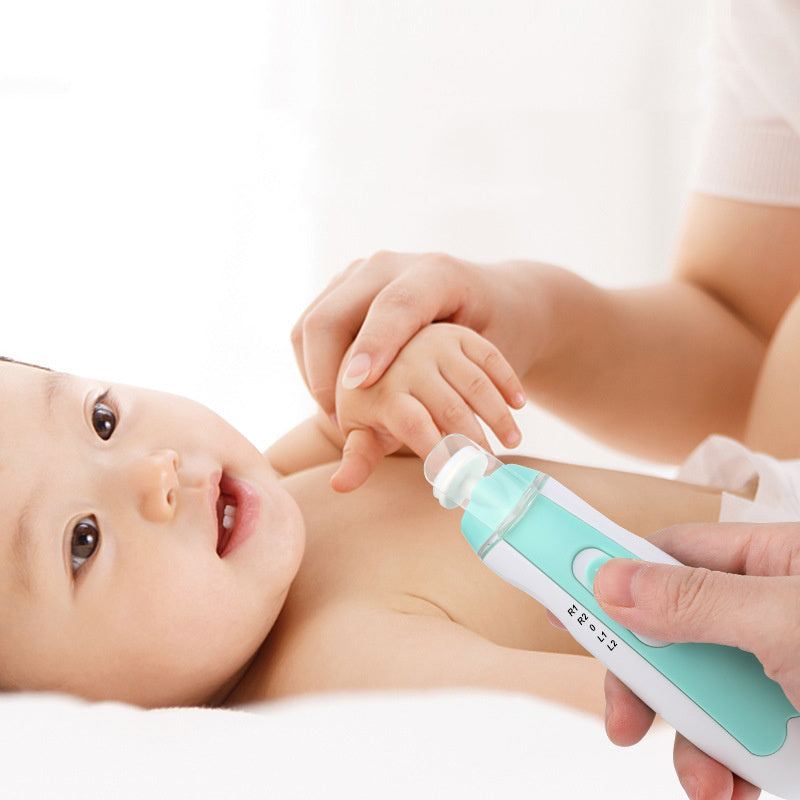 Baby lying down with a green and white device held by an adult hand on a white background