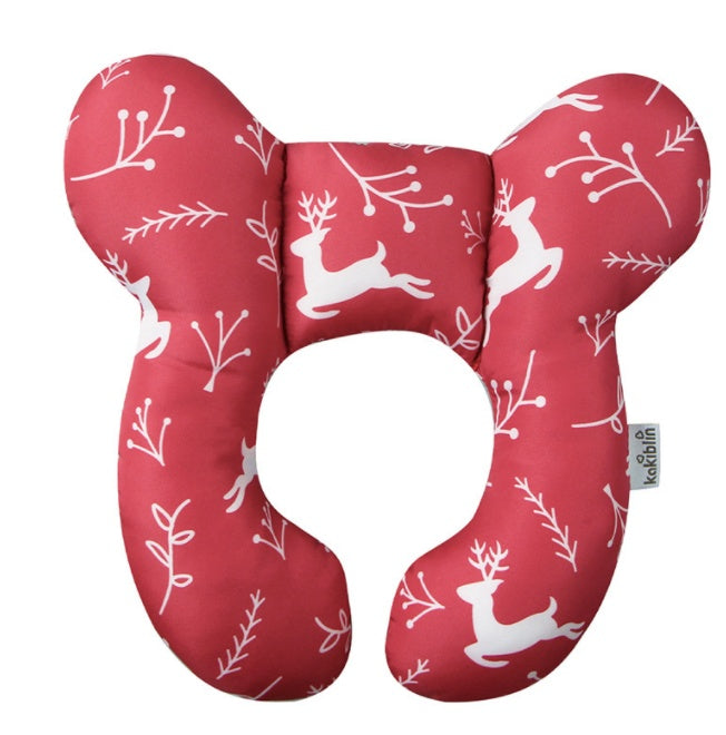 Red neck pillow with white reindeer and branch patterns on a white background