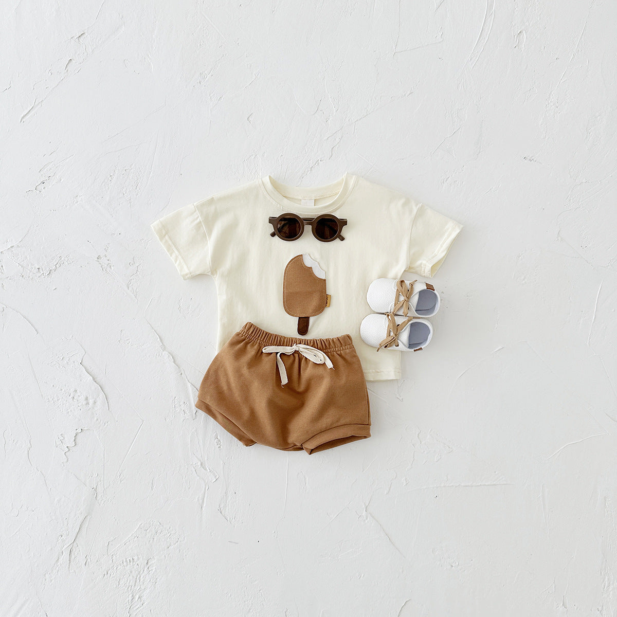 Children's outfit with t-shirt and shorts on a white background