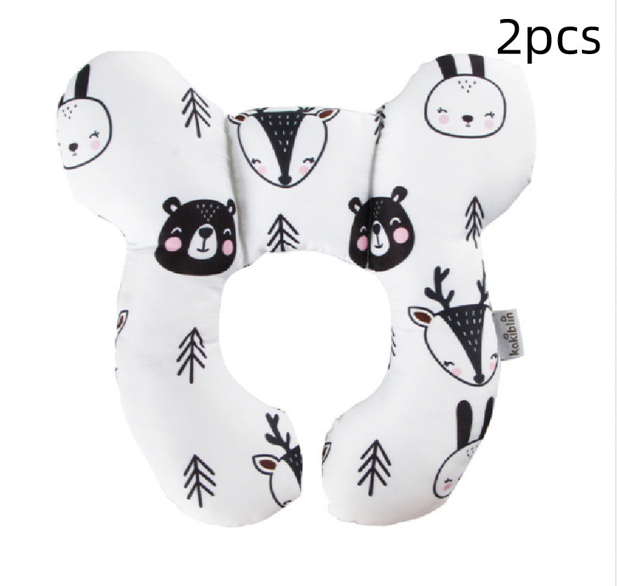 Two white neck pillows with black animal prints on a white background