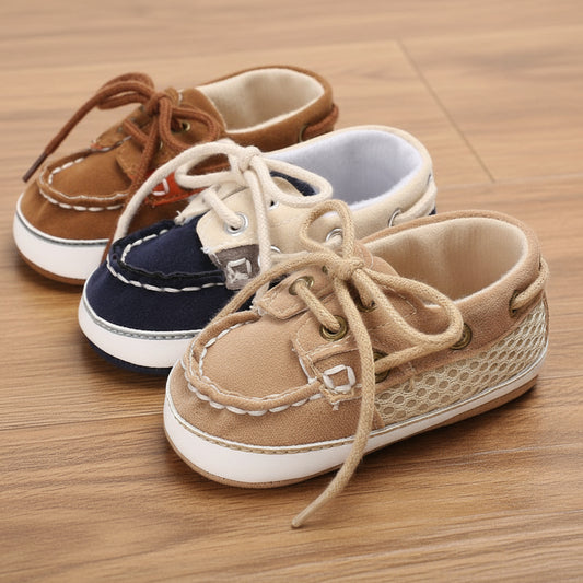 Three pairs of children's boat shoes in brown, blue, and beige on a white background.