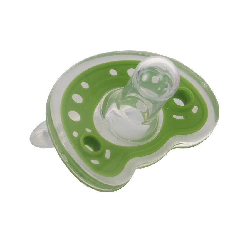 Green and clear baby pacifier on a white background