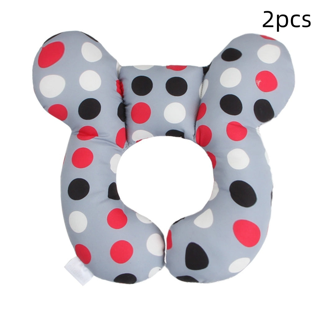 Two butterfly-shaped polka dot pillows on a white background