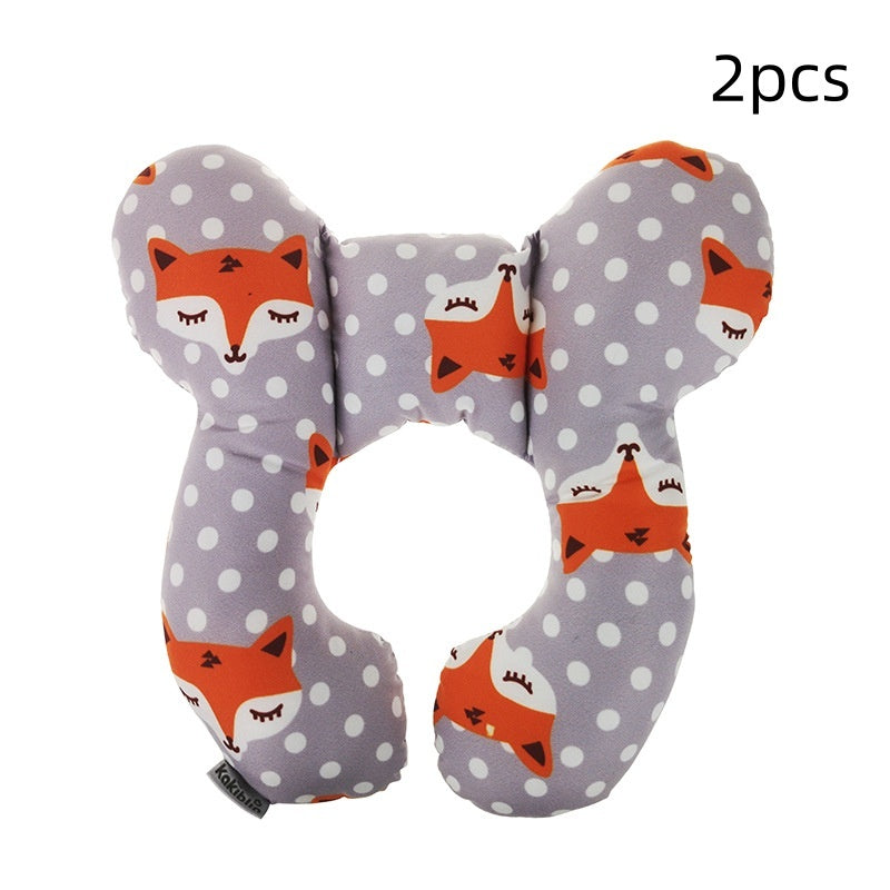 Two U-shaped travel pillows with fox pattern on a gray background