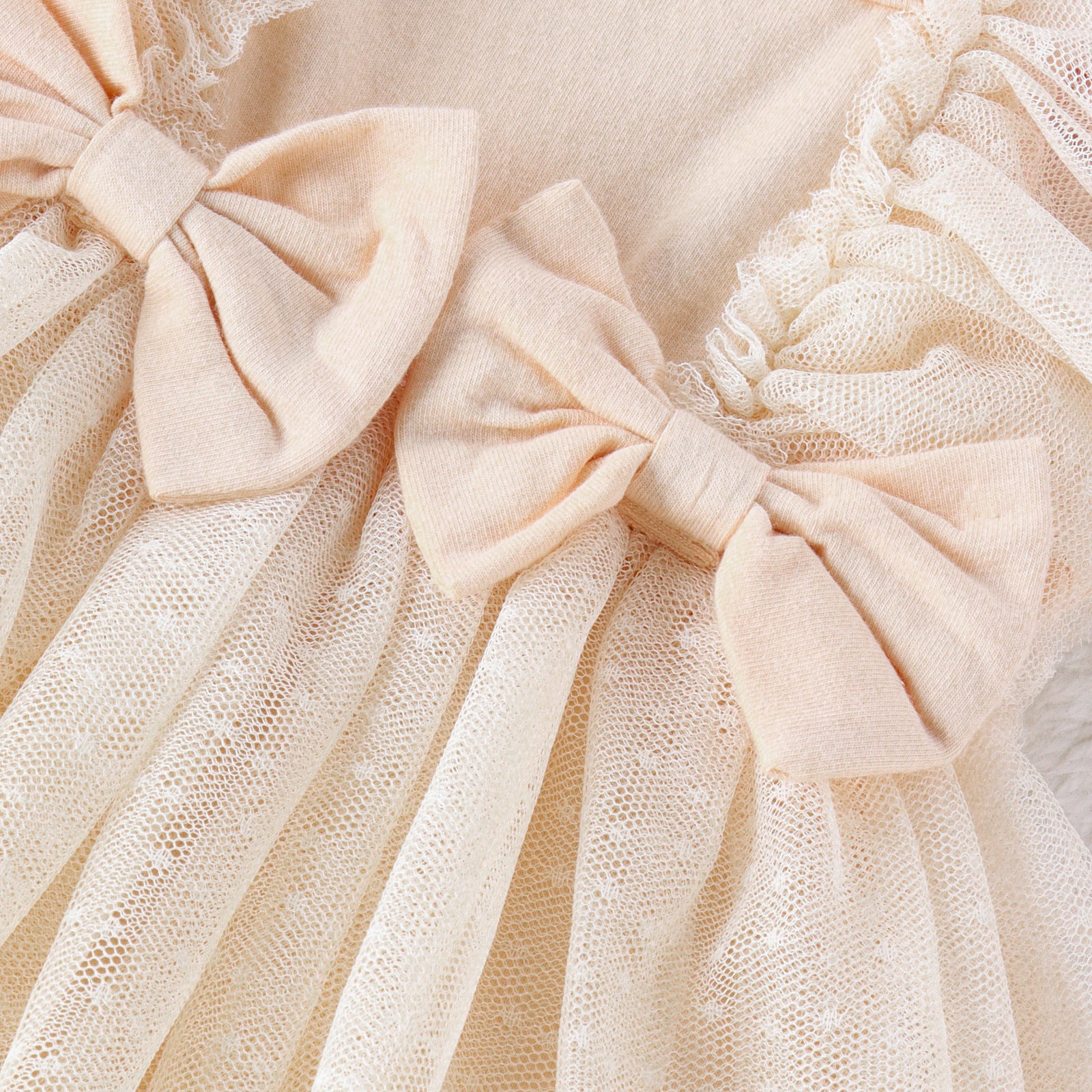 Close-up of beige fabric with a bow detail