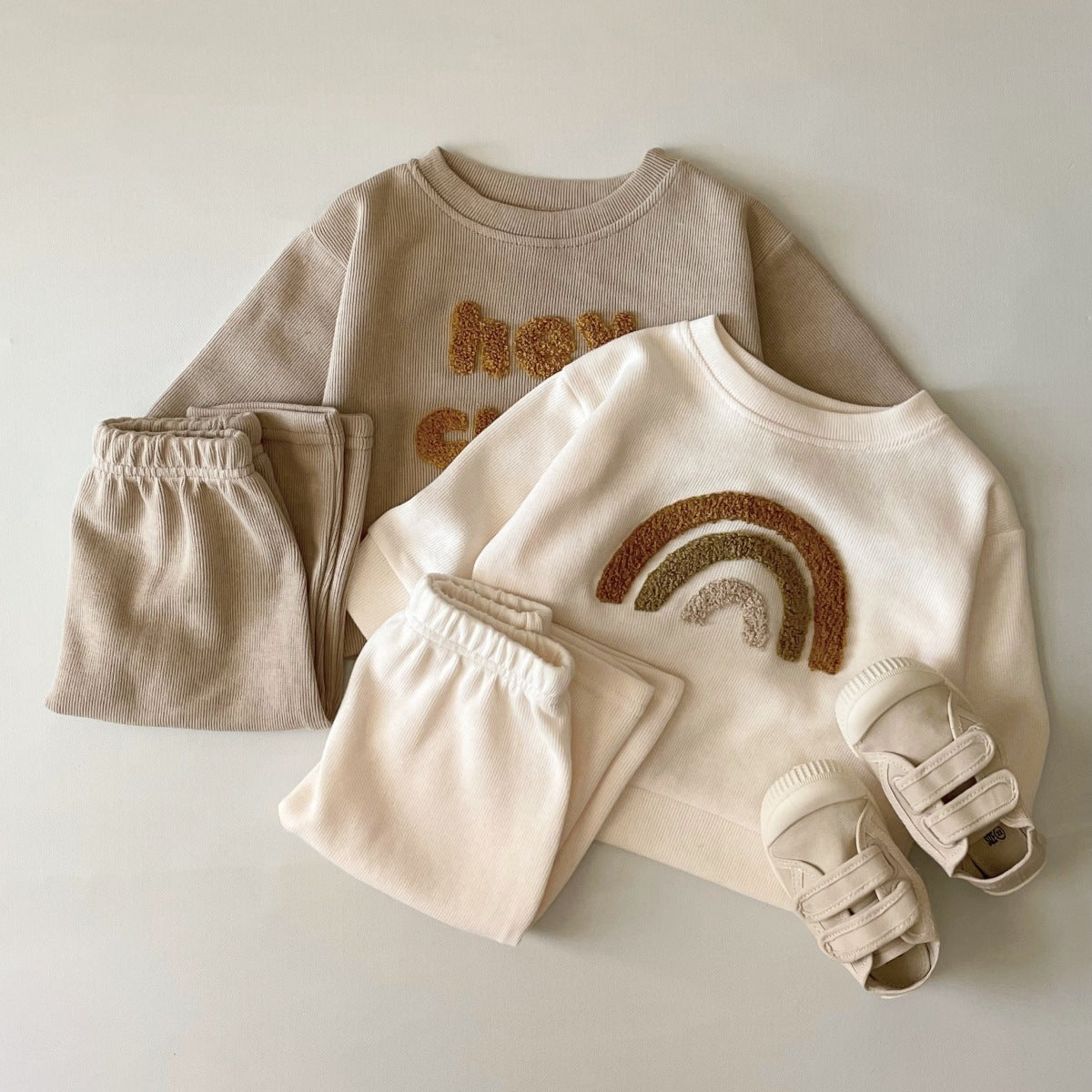 Baby in long sleeve embroidered sweater with matching full-length pants